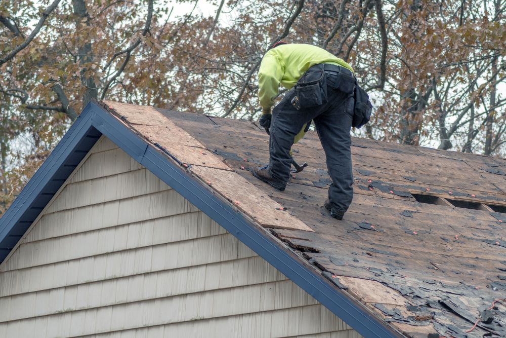 roofer fixing old roof