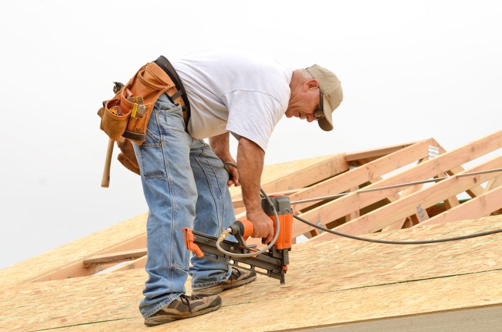 roofer drilling on the roof