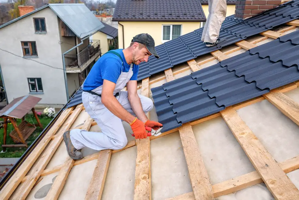 Roofer cutting a 29 gauge metal roof panel.