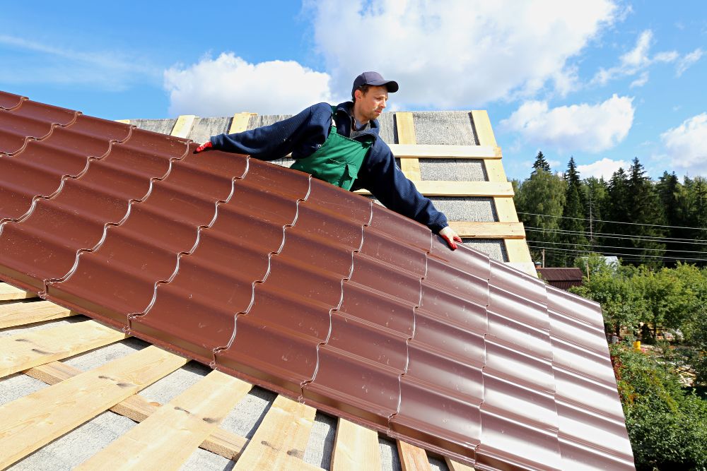 Roofer holding metal sheet roofing