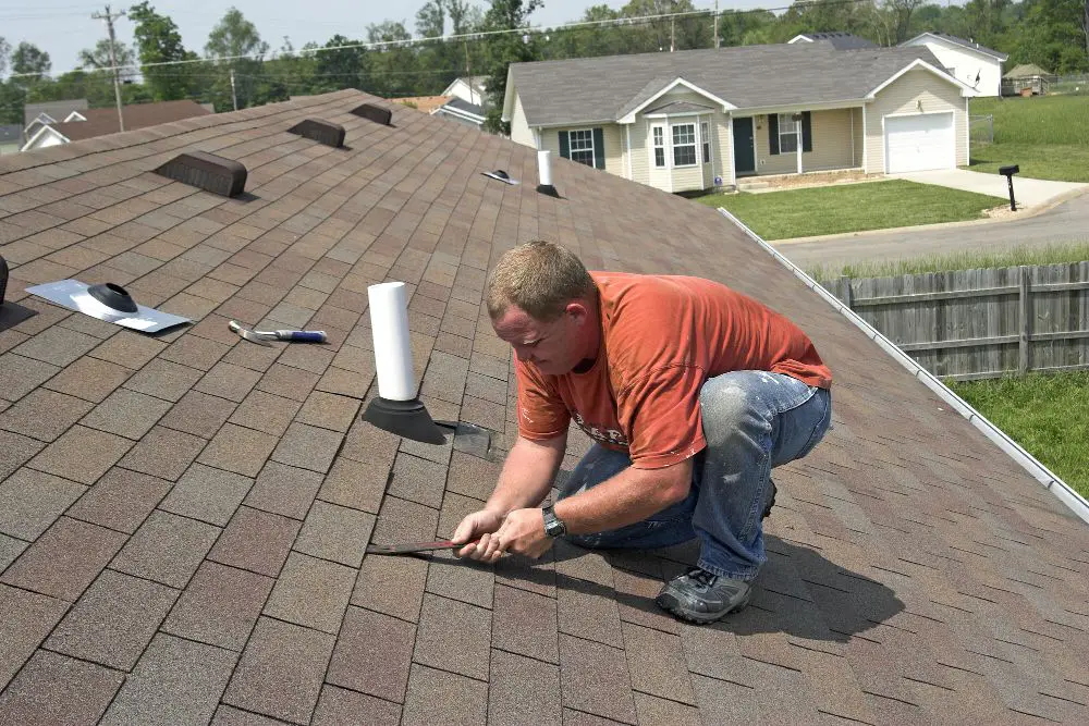 Roofer removing tile roof