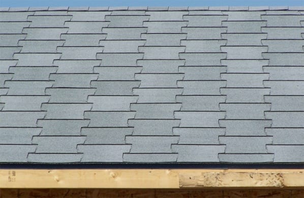 A view of T-lock shingles on a house roof.